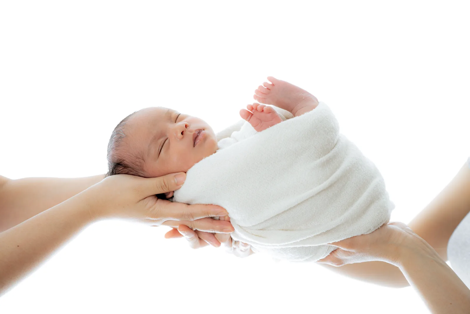 Newborn safely cradled in gentle hands