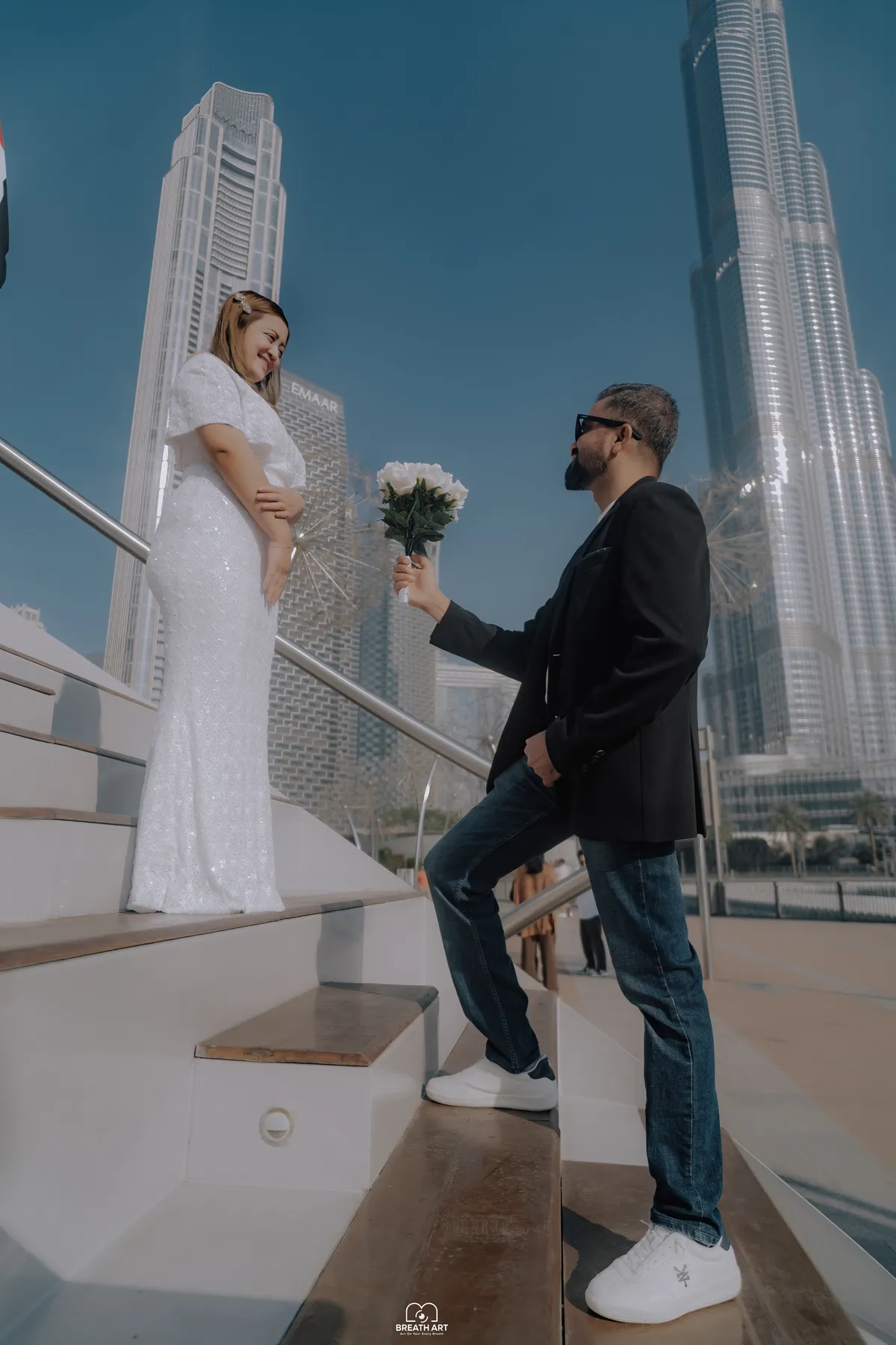 Couple pre-wedding photoshoot on the steps in front of the Burj Khalifa, Downtown Dubai, by BreathART